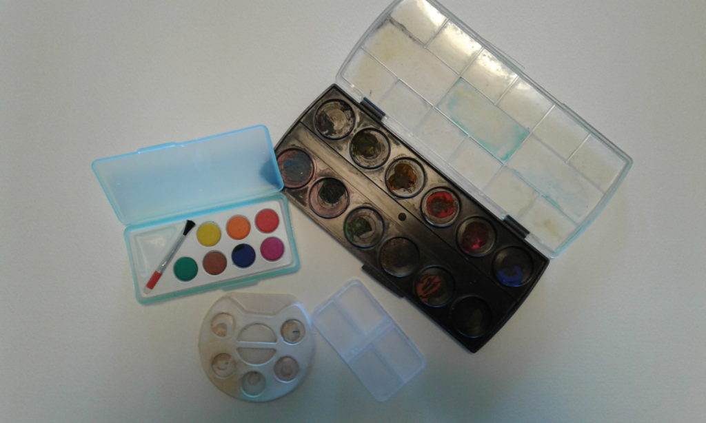 assorted children's paint palettes and pill box.